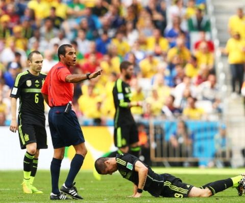 CURITIBA, BRAZIL - JUNE 23: Referee Nawaf Shukralla gestures after a challenge between Fernando Torres of Spain and Mile Jedinak of Australia during the 2014 FIFA World Cup Brazil Group B match between Australia and Spain at Arena da Baixada on June 23, 2014 in Curitiba, Brazil.  (Photo by Cameron Spencer/Getty Images)