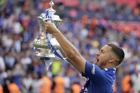 Chelsea's Eden Hazard celebrates with the trophy after winning the English FA Cup final soccer match between Chelsea and Manchester United at Wembley stadium in London, Saturday, May 19, 2018. Chelsea defeated Manchester United 1-0. (AP Photo/Tim Ireland)