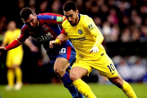 Chelsea's Eden Hazard in action with Crystal Palace's James McArthur, left, during their English Premier League soccer match at Selhurst Park in London, Sunday Dec. 30, 2018. (John Walton/PA via AP)