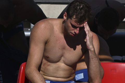 Alexandros Papanastasiou of Greece sits in dejection at the end of the Men's water polo semifinal match between Italy and Greece at the 19th FINA World Championships in Budapest, Hungary, Friday, July 1, 2022. (AP Photo/Anna Szilagyi)