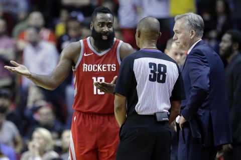 Houston Rockets guard James Harden (13) argues a call with referee Michael Smith (38) as head coach Mike D'Antoni listens in the second half of an NBA basketball game against the Los Angeles Lakers Wednesday, Dec. 20, 2017, in Houston. (AP Photo/Michael Wyke)