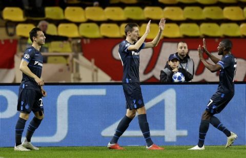 Brugge midfielder Hans Vanaken, center, celebrates his goal during the Champions League Group A soccer match between Monaco and Club Brugge at the Louis II stadium in Monaco, Tuesday, Nov. 6, 2018. (AP Photo/Claude Paris)