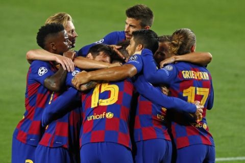 Barcelona's Clement Lenglet, center, celebrates after scoring the opening goal during the Champions League round of 16, second leg soccer match between Barcelona and Napoli at the Camp Nou Stadium in Barcelona, Spain, Saturday, Aug. 8, 2020. (AP Photo/Joan Monfort)