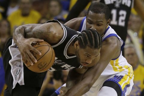 San Antonio Spurs forward Kawhi Leonard, left, dribbles against Golden State Warriors forward Kevin Durant during Game 1 of the NBA basketball Western Conference finals in Oakland, Calif., Sunday, May 14, 2017. (AP Photo/Jeff Chiu)