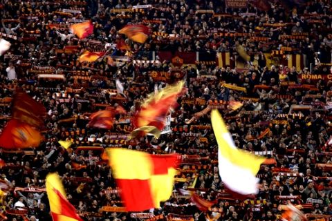 Roma fans wave flags prior to the Champions League quarterfinal second leg soccer match between between Roma and FC Barcelona, at Rome's Olympic Stadium, Tuesday, April 10, 2018. (AP Photo/Gregorio Borgia)