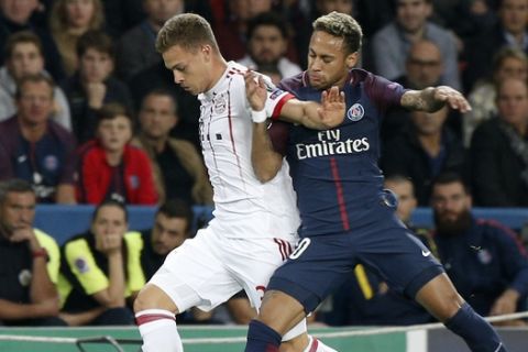 Bayern's Joshua Kimmich, left, and PSG's Neymar challenge for the ball during the Champions League soccer match between Paris Saint Germain and Bayern Munich in Paris, France, Wednesday, Sept. 27, 2017. (AP Photo/Thibault Camus)