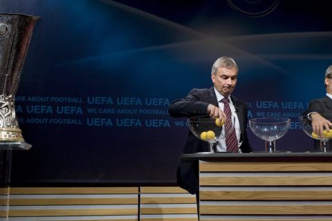 UEFA General Secretary David Taylor, left, and Giorgio Marchetti, right, UEFA Director of professional football, removes the balls containing the names of the soccer clubs, during the drawing of the games for the Europa League 2009/10 Play Off round, at the UEFA Headquarters in Nyon, Switzerland, Friday, Aug. 7, 2009. (AP Photo/Keystone/Salvatore Di Nolfi)