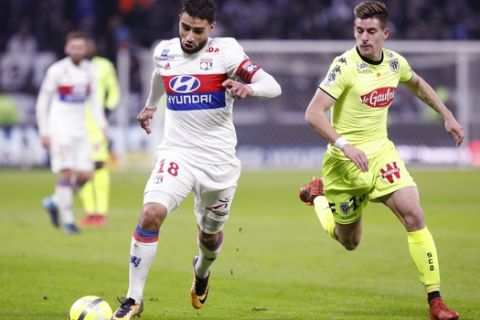 Lyon's Nabil Fekir, left, runs with the ball with Angers' Baptiste Santamaria, during their French League One soccer match in Decines, near Lyon, central France, Sunday, Jan. 14, 2018. (AP Photo/Laurent Cipriani)
