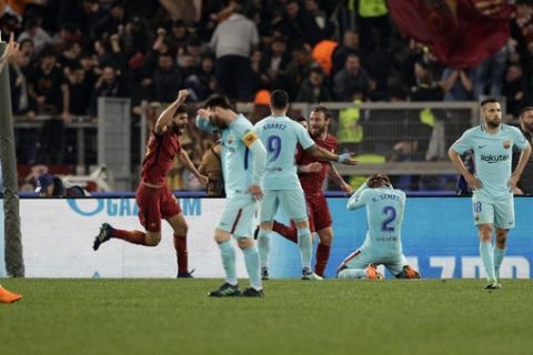 Players react after Roma's Kostas Manolas scored his side's 3rd goal, during the Champions League quarterfinal second leg soccer match between Roma and FC Barcelona at Rome's Olympic Stadium, Tuesday, April 10, 2018. (AP Photo/Andrew Medichini)