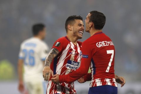 Atletico's Antoine Griezmann, right, celebrates with teammate Lucas Hernandez after their team scored 3-0 during the Europa League Final soccer match between Marseille and Atletico Madrid at the Stade de Lyon in Decines, outside Lyon, France, Wednesday, May 16, 2018. (AP Photo/Francois Mori)