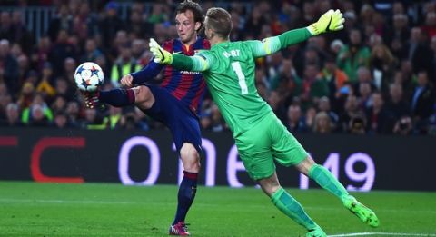 BARCELONA, SPAIN - MARCH 18: Ivan Rakitic of Barcelona lifts the ball over Joe Hart of Manchester City to score the opening goal during the UEFA Champions League Round of 16 second leg match between Barcelona and Manchester City at Camp Nou on March 18, 2015 in Barcelona, Spain.  (Photo by Michael Regan/Getty Images)