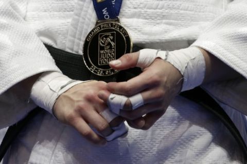 Kaja Kajzer of Slovenia holds her hands with the gold medal after winning the Judo under 57 kg final in the Tel Aviv Grand Prix 2020 in Tel Aviv, Israel, Thursday, Jan. 23, 2020. (AP Photo/Ariel Schalit)