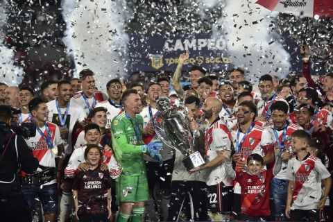 Argentina's River Plate players hold their trophy and celebrate winning the local soccer tournament at Monumental stadium in Buenos Aires, Argentina Thursday, Nov. 25, 2021. River defeated Racing 4-0 and became the tournament champions. (AP Photo/Gustavo Garello)
