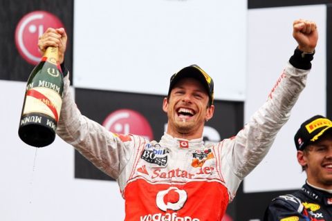 MONTREAL, CANADA - JUNE 12:  Jenson Button of Great Britain and McLaren celebrates on the podium after winning the Canadian Formula One Grand Prix at the Circuit Gilles Villeneuve on June 12, 2011 in Montreal, Canada.  (Photo by Clive Rose/Getty Images)