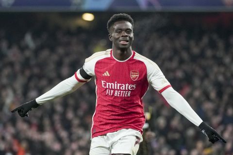 Arsenal's Bukayo Saka celebrates after scoring his side's third goal during the Champions League Group B soccer match between Arsenal and Lens, at Emirates stadium, in London, Wednesday, Nov. 29, 2023. (AP Photo/Kin Cheung)