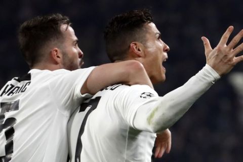 Juventus' Cristiano Ronaldo celebrates, with Miralem Pjanic, left, after scoring his side's second goal during the Champions League round of 16, 2nd leg, soccer match between Juventus and Atletico Madrid at the Allianz stadium in Turin, Italy, Tuesday, March 12, 2019. (AP Photo/Antonio Calanni)