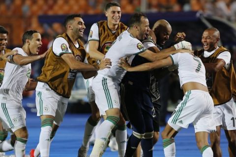 Algerian players celebrate after the African Cup of Nations semifinal soccer match between Algeria and Nigeria in Cairo International stadium in Cairo, Egypt, Sunday, July 14, 2019. (AP Photo/Amr Nabil)