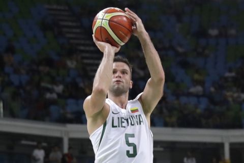 Lithuania's Mantas Kalnietis (5) drives to the basket over Nigeria's Andy Ogide (11) during a basketball game at the 2016 Summer Olympics in Rio de Janeiro, Brazil, Tuesday, Aug. 9, 2016. (AP Photo/Charlie Neibergall)