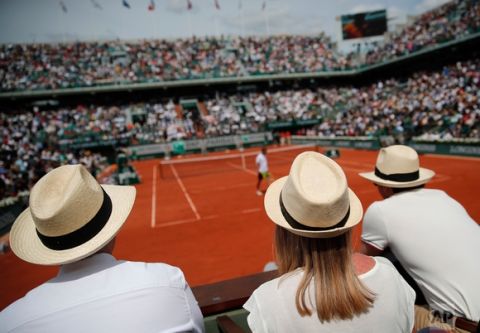 Guests watch a match on Chatrier court during the French Open tennis tournament at the Roland Garros stadium, Sunday, June 4, 2017 in Paris. (AP Photo/Christophe Ena)