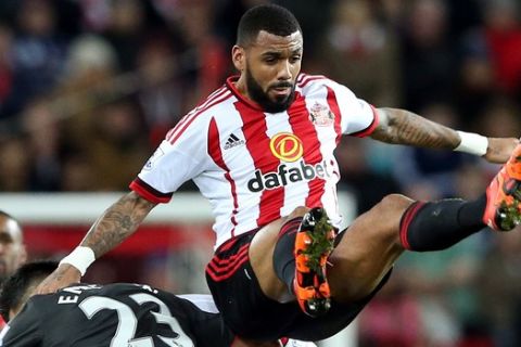 Sunderland's Yann M'Vila, top, vies for the ball with Liverpool's Emre Can, left, during the English Premier League soccer match between Sunderland and Liverpool at the Stadium of Light, Sunderland, England, Wednesday, Dec. 30, 2015. (AP Photo/Scott Heppell)