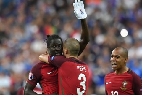 Portugal's forward Eder (L) celebrates with Portugal's defender Pepe (C) and Portugal's midfielder Joao Mario after he scored during the Euro 2016 final football match between Portugal and France at the Stade de France in Saint-Denis, north of Paris, on July 10, 2016. / AFP / FRANCISCO LEONG        (Photo credit should read FRANCISCO LEONG/AFP/Getty Images)