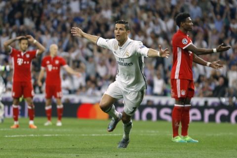 Real Madrid's Cristiano Ronaldo, center, celebrates after scoring as Bayern players react during the Champions League quarterfinal second leg soccer match between Real Madrid and Bayern Munich at Santiago Bernabeu stadium in Madrid, Spain, Tuesday April 18, 2017. (AP Photo/Francisco Seco)