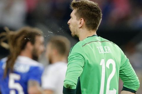 Germany's goalkeeper Ron-Robert Zieler spits after the US scored their second goal during the soccer friendly match between Germany and the United States in Cologne, western Germany, Wednesday, June 10, 2015. (AP Photo/Frank Augstein)