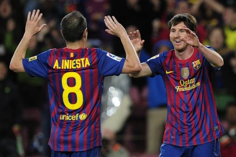 Barcelona's Argentinian forward Lionel Messi (R) celebrates with teammate Barcelona's midfielder Andres Iniesta (L) after scoring during the Spanish league football match FC Barcelona vs Getafe CF on April 10, 2012 at the Camp Nou stadium in Barcelona. AFP PHOTO/ JOSEP LAGO (Photo credit should read JOSEP LAGO/AFP/Getty Images)
