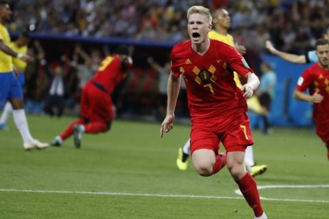 Belgium's Kevin De Bruyne, center, celebrates after scoring his side's second goal during the quarterfinal match between Brazil and Belgium at the 2018 soccer World Cup in the Kazan Arena, in Kazan, Russia, Friday, July 6, 2018. (AP Photo/Frank Augstein)