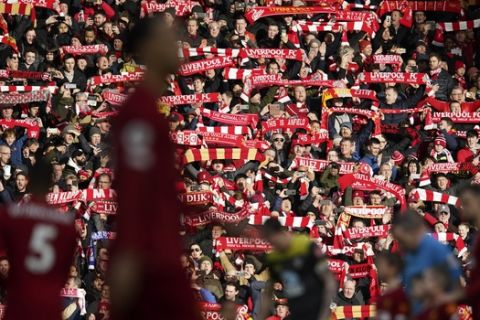 Fans hold up scarfs prior the start of the English Premier League soccer match between Liverpool and Southampton at Anfield Stadium, Liverpool, England, Saturday, February 1, 2020. (AP Photo/Jon Super)