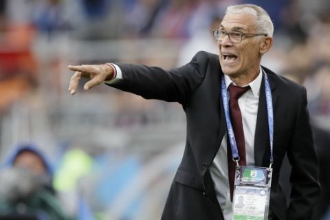 Egypt head coach Hector Cuper instructs his team during the group A match between Egypt and Uruguay at the 2018 soccer World Cup in the Yekaterinburg Arena in Yekaterinburg, Russia, Friday, June 15, 2018. (AP Photo/Mark Baker)