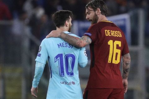 Barcelona's Lionel Messi, left, and Roma's Daniele De Rossi talk as they walk off the pitch during half time in the Champions League quarterfinal second leg soccer match between between Roma and FC Barcelona, at Rome's Olympic Stadium, Tuesday, April 10, 2018. (AP Photo/Gregorio Borgia)