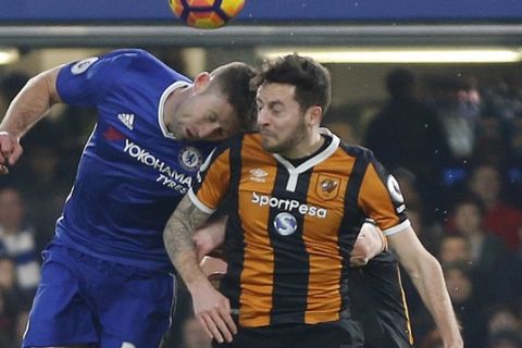Chelsea's Gary Cahill, left, and Hull City's Ryan Mason challenge for the ball during the English Premier League soccer match between Chelsea and Hull City at Stamford Bridge stadium in London, Sunday, Jan. 22, 2017. (AP Photo/Frank Augstein)