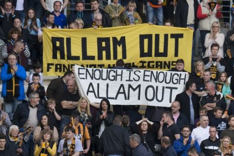 Hull City supporters demonstrate against the club's owner Assem Allam after the team are relegated from the English Premier League following their soccer match against Manchester United at the KC Stadium, Hull, England, Sunday May 24, 2015. (AP Photo/Jon Super)