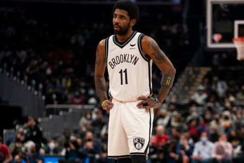 Brooklyn Nets guard Kyrie Irving (11) pauses during the first half of an NBA basketball game against the Washington Wizards, Wednesday, Jan. 19, 2022, in Washington. (AP Photo/Evan Vucci)
