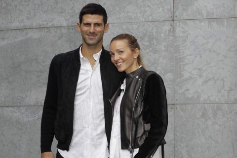 Serbian Tennis star Novak Djokovic, left, flanked by his wife Jelena pose for photographers prior to the start of a Giorgio Armani women's Spring-Summer 2017 fashion show, that was presented in Milan, Italy, Friday, Sept. 23, 2016. (AP Photo/Luca Bruno)