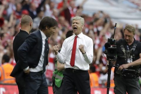 Arsenal team manager Arsene Wenger, right, celebrates his team's victory next to Chelsea team manager Antonio Conte, left, during the English FA Cup final soccer match between Arsenal and Chelsea at the Wembley stadium in London, Saturday, May 27, 2017. (AP Photo/Matt Dunham)