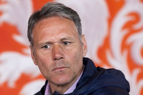 FILE - In this Friday, May 20, 2016 file photo, Dutch former soccer star Marco van Basten is seated in front of the logo of the Dutch soccer association KNVB during a presentation of video referee assistance in Amsterdam, Netherlands. Former AC Milan and Netherlands forward Marco van Basten is using his role as technical director at FIFA to propose a series of changes to soccer to stir a debate. (AP Photo/Peter Dejong, File)