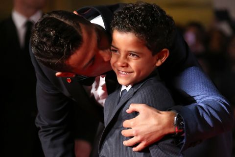 Cristiano Ronaldo, left, kisses his son Cristiano Ronaldo Junior as they pose for photographers upon arrival at the world premiere of the film 'Ronaldo, in London, Monday, Nov. 9, 2015. (Photo by Joel Ryan/Invision/AP)