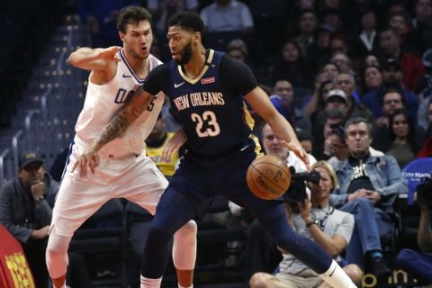 New Orleans Pelicans' Anthony Davis, right, dribbles against Los Angeles Clippers' Danilo Gallinari during the first half of an NBA basketball game Monday, Jan. 14, 2019, in Los Angeles. (AP Photo/Ringo H.W. Chiu)
