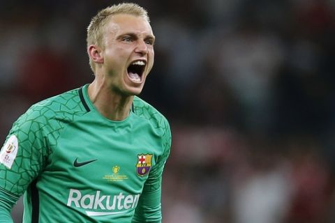 Barcelona goalkeeper Jasper Cillessen celebrates after Luis Suarez scoring his side's opening goal during the Copa del Rey final soccer match between Barcelona and Sevilla at the Wanda Metropolitano stadium in Madrid, Spain, Saturday, April 21, 2018. (AP Photo/Paul White)