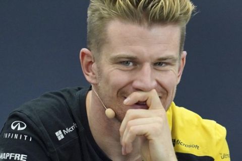 Renault driver Nico Hulkenberg, left, of Germany and Red Bull driver Max Verstappen of the Netherlands listen to a reporter's questions during a press conference for the Japanese Formula One Grand Prix at Suzuka Circuit in Suzuka, Thursday, Oct. 10, 2019. (AP Photo/Toru Hanai)