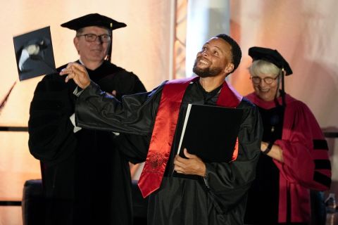 Golden State Warriors Stephen Curry tosses his cap in the air after his graduation ceremony at Davidson College on Wednesday, Aug. 31, 2022, in Davidson, N.C. Curry was also inducted into the school's Hall of Fame and his number and jersey were retired during the event. (AP Photo/Chris Carlson)
