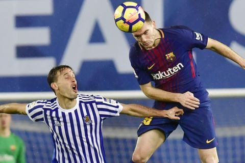 FC Barcelona's Thomas Vermaelen, center, duels for the ball with Real Sociedad's Sergio Canales during the Spanish La Liga soccer match between Barcelona and Real Sociedad, at Anoeta stadium, in San Sebastian, northern Spain, Sunday, Jan.14, 2018. (AP Photo/Alvaro Barrientos)
