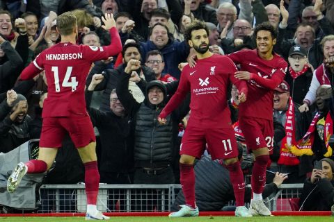 Liverpool's Mohamed Salah, center, celebrates with teammates after scoring his side's opening goal during the English Premier League soccer match between Liverpool and Manchester City at Anfield stadium in Liverpool, Sunday, Oct. 16, 2022. (AP Photo/Jon Super)
