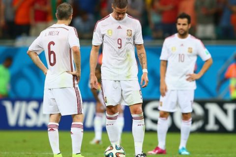 SALVADOR, BRAZIL - JUNE 13:  (L - R) Andres Iniesta; Fernando Torres and Cesc Fabregas of Spain look dejected pduring the 2014 FIFA World Cup Brazil Group B match between Spain and Netherlands at Arena Fonte Nova on June 13, 2014 in Salvador, Brazil.  (Photo by Quinn Rooney/Getty Images)
