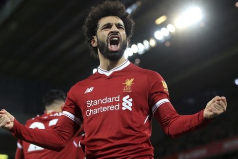 Liverpool's Mohamed Salah celebrates scoring his side's second goal against Leicester City during the English Premier League soccer match at Anfield, Liverpool, England, Saturday Dec. 30, 2017. (Peter Byrne/PA via AP)