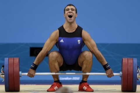 Greece's David Kavelasvili competes during the men's 94-kg weightlifting competition at the 2012 Summer Olympics, Saturday, Aug. 4, 2012, in London. (AP Photo/Mike Groll)
