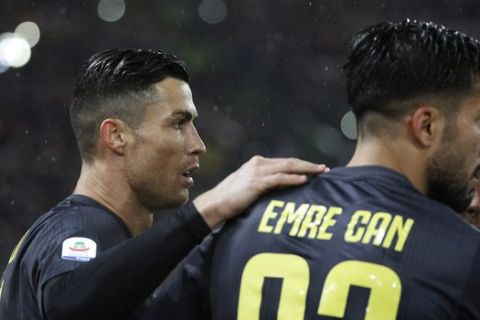 Juventus' Cristiano Ronaldo, left, celebrates with his teammates Emre Can, center, and Paulo Dybala after scoring his side's second goal during the Serie A soccer match between Lazio and Juventus at the Olympic stadium, in Rome, Sunday, Jan. 27, 2019. (AP Photo/Gregorio Borgia)