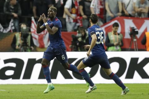 Manchester's Paul Pogba, left, celebrates after scoring the opening goal during the soccer Europa League final between Ajax Amsterdam and Manchester United at the Friends Arena in Stockholm, Sweden, Wednesday, May 24, 2017. (AP Photo/Michael Sohn)